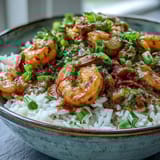 A spoonful of rich, dark roux-based Classic New Orleans Étouffée featuring succulent shrimp in a hearty Creole sauce.