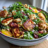 Halloumi Blood Orange Fattoush salad tossed with cucumber, cherry tomatoes, and red onion in a zesty sumac dressing.