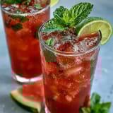 Chilled watermelon mint spritz mocktail, alcohol-free and bursting with juicy fruit flavor, ideal for hot afternoons.