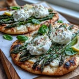 Vibrant roasted asparagus flatbread, burrata, and lemon—a delightful appetizer for any occasion.