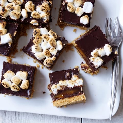 S'mores Bars stacked on a plate, ready to serve after a quick 40-minute bake time for dessert.