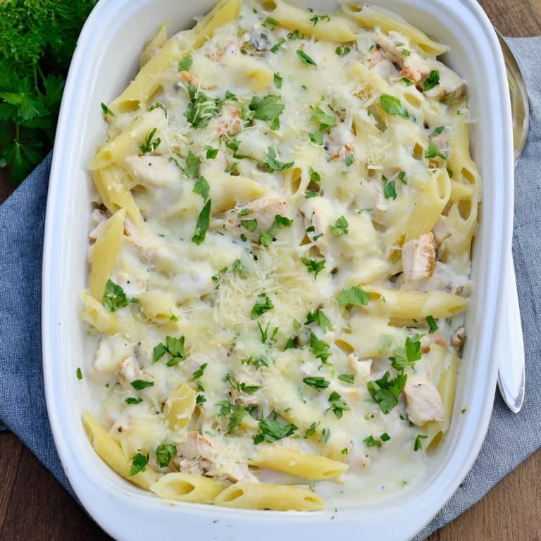Fresh parsley garnishes this hearty Chicken Alfredo Bake straight from the oven.