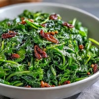 Fresh arugula salad with tangy lemon vinaigrette and delicate Parmesan shavings, ideal for a light lunch or side dish.