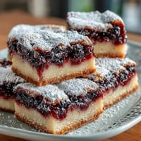 Vibrant blackberry lemon bars with flaky shortbread crust, swirled and tangy.